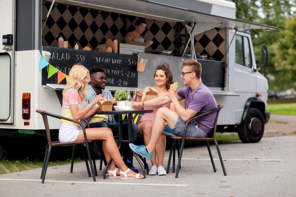 group of friends eating at a food truck