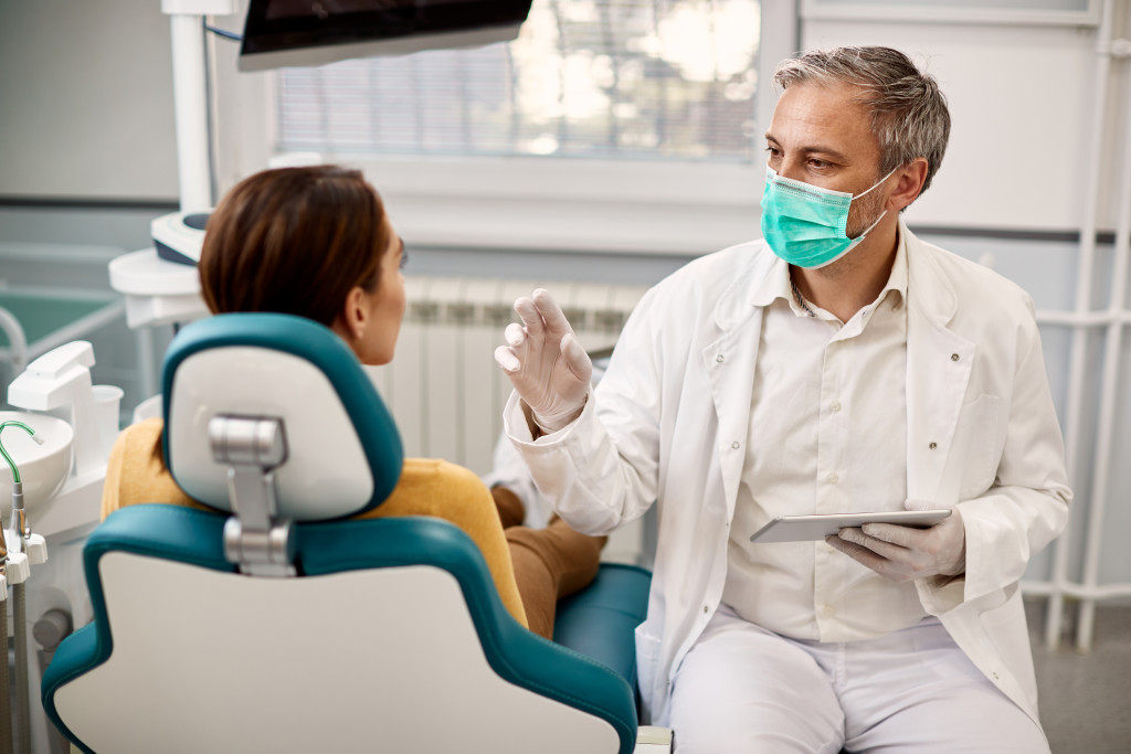 Dentist communicating with the patient in chair