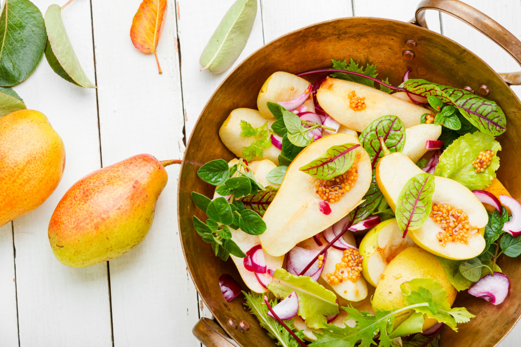 Fresh autumn salad.Appetizing salad with pear and herbs.
