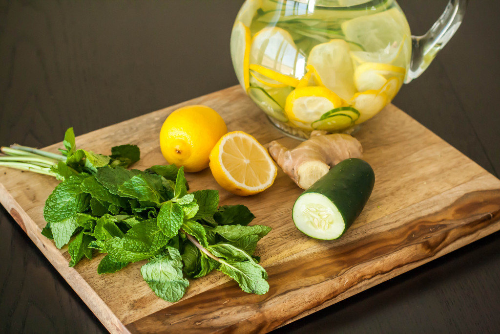 Water in a pitcher, infused with mint, lemon, ginger, and cucumber