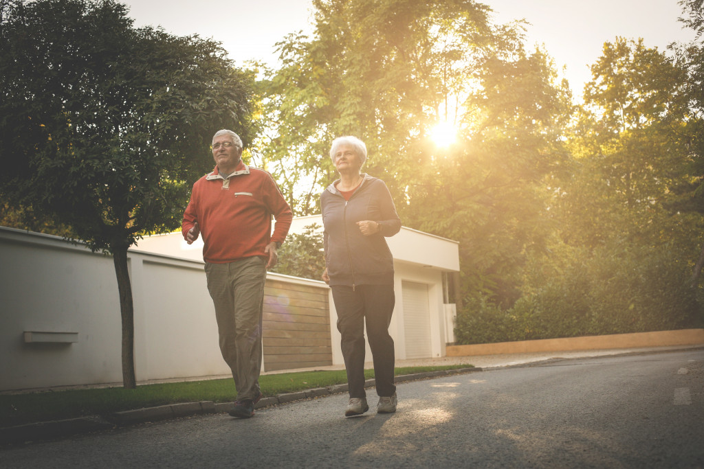 elderly man and woman brisk walking in the morning outdoors
