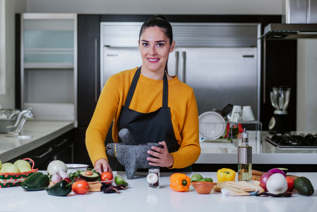 woman cooking healthy ingredients in kitchen