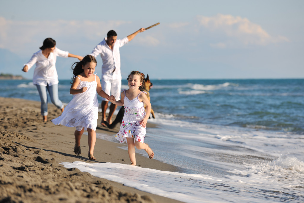 Whole family running on a beach