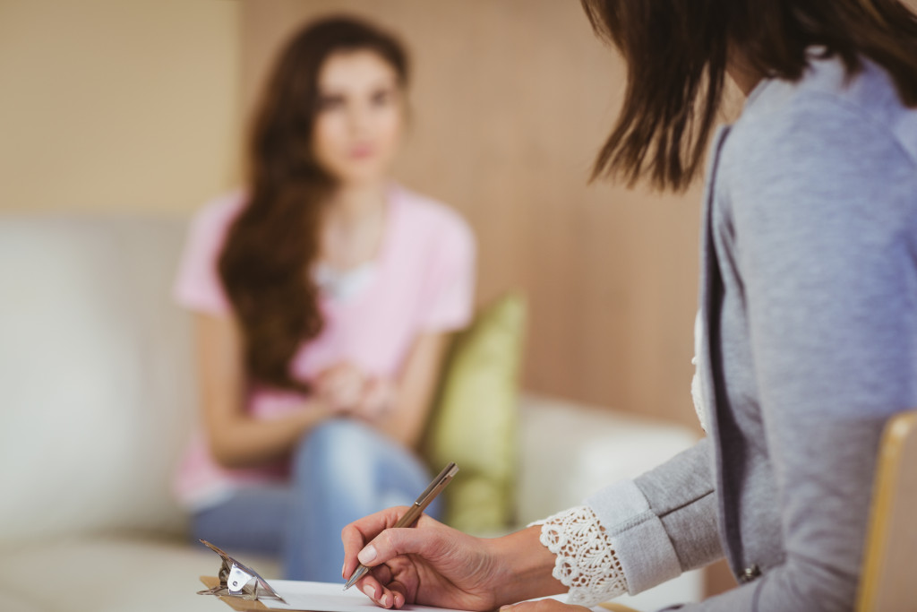 female patient talking to a female therapist in a office