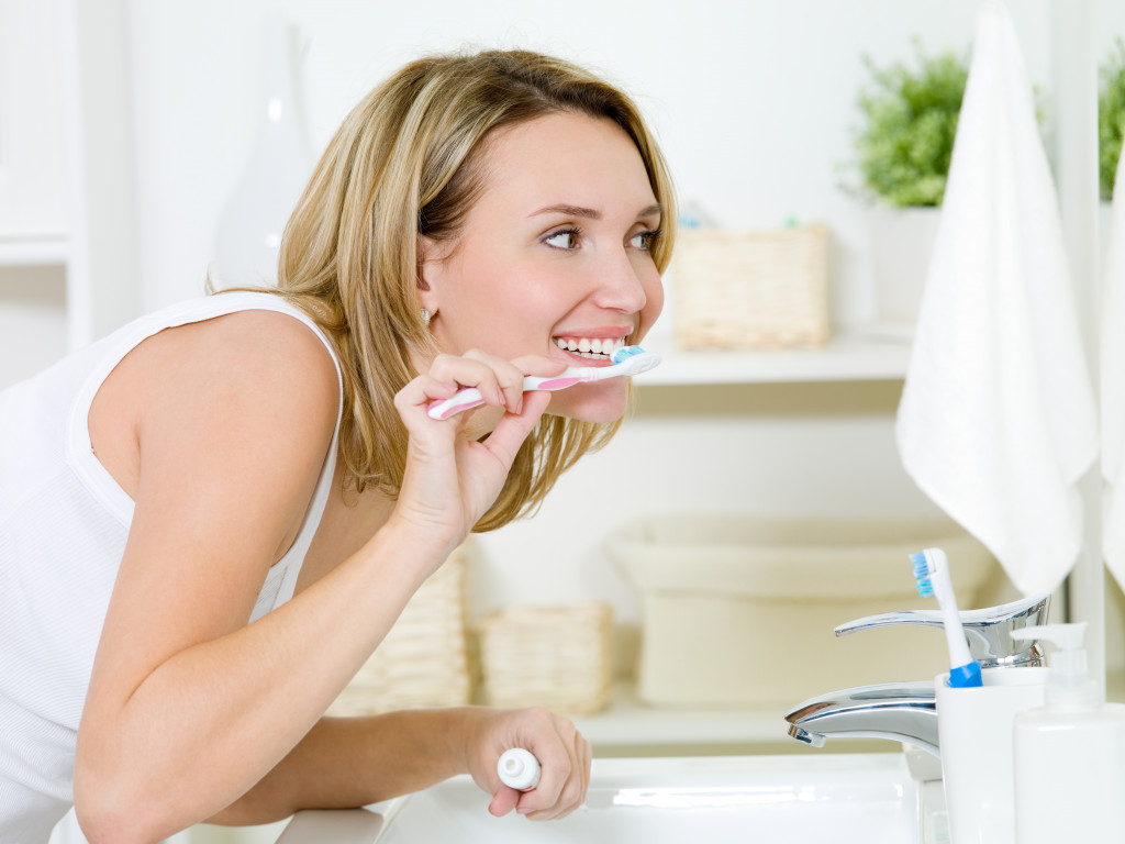 beautiful woman brushing her teeth